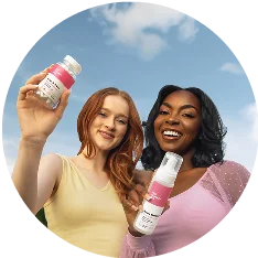 Two women smiling outdoors holding Her Fantasy Box Fresh & Clean suppositories and Boric Balance feminine wash.