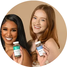 Two women smiling and holding Her Fantasy Box Body Magic and Slippery Box supplement bottles.